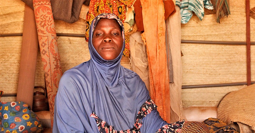 Woman wearing light blue headscarf in a shelter in Burkina Faso