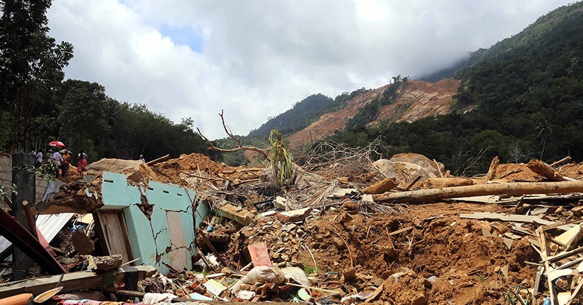 Hillside with marks left by landslide and debris at bottom of hill in Sri Lanka