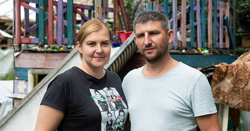 Ukrainian couple stand in front of a children's slide