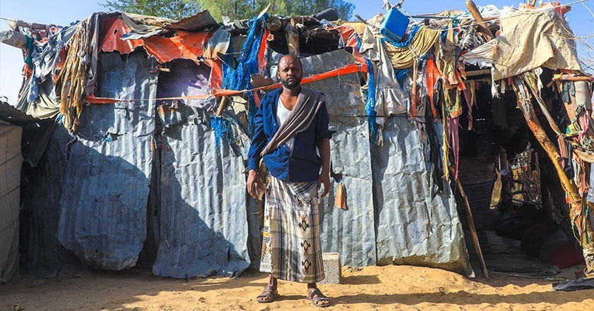 man standing in front of shelter in yemen